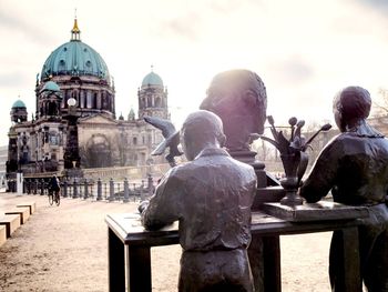 Statue in temple against sky