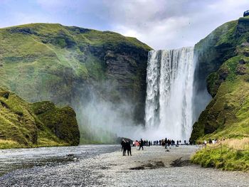 Scenic view of waterfall against sky