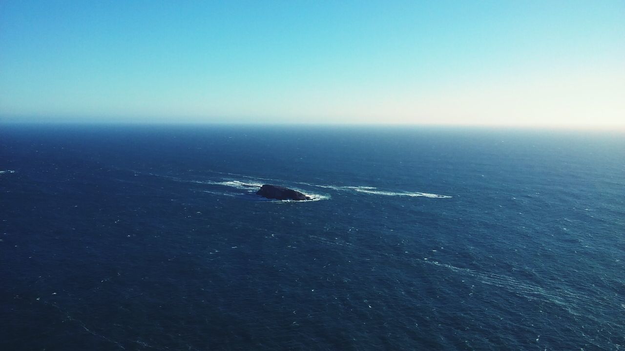 sea, horizon over water, water, clear sky, copy space, scenics, tranquil scene, tranquility, beauty in nature, blue, nature, beach, transportation, shore, sky, idyllic, seascape, mode of transport, nautical vessel, outdoors