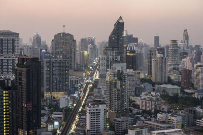 Aerial view of modern buildings in city against sky