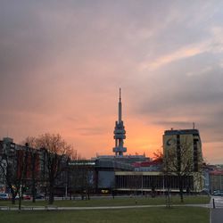 Building against cloudy sky at sunset