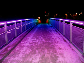 Illuminated bridge at night