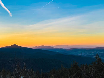 Scenic view of silhouette mountains against sky at sunset