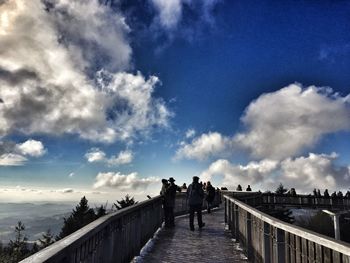 Panoramic view of people on road against sky