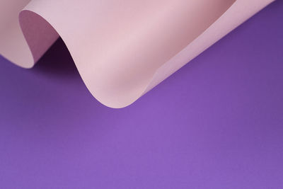 Geometric curved pastel pink and purple paper with light and shadows. abstract geometry background