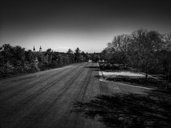 Road in city against clear sky