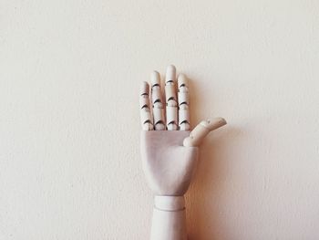 Close-up of human hand on white wall