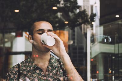 Portrait of man holding coffee cup