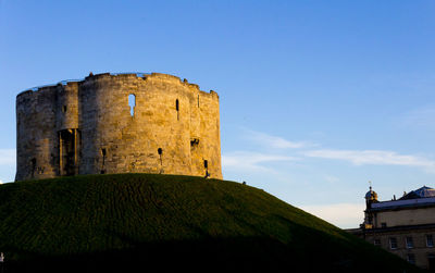 Low angle view of fort against blue sky