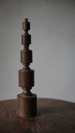 Close-up of stack on table against wall