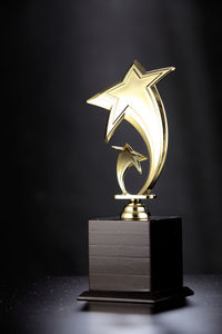 Close-up of award on table against wall