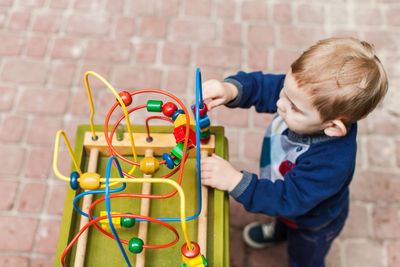 Boy holding multi colored playing with umbrella