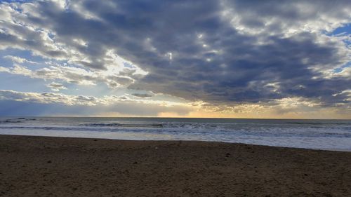 Scenic view of beach against sky during sunset