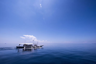 Scenic view of sea against blue sky