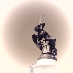 Low angle view of statue against sky