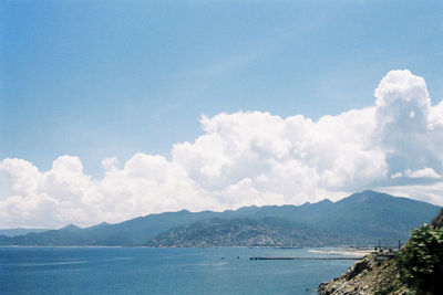 Scenic view of calm sea against cloudy sky