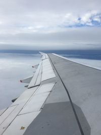 Airplane wing against sky