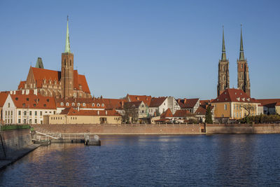 View of buildings in city against clear sky