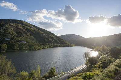 Scenic view of lake and mountains against sky