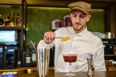 Bartender preparing drink at bar