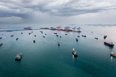 Group of transport ships waiting to carry oil,gas,petrochemicals for export,floating in sea 