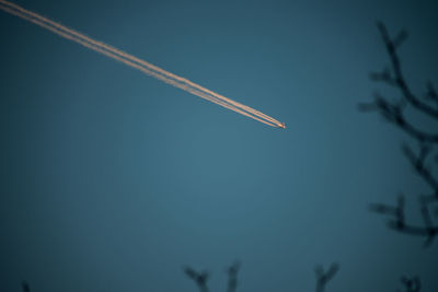 Low angle view of vapor trail against clear sky