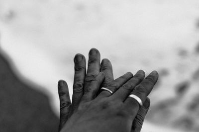 Close-up of hand against sky