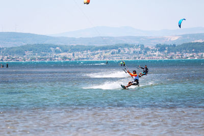 Man surfing in sea against sky