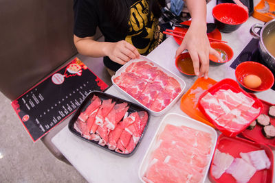 High angle view of man preparing food on table