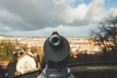 Close-up of coin-operated binoculars against sky