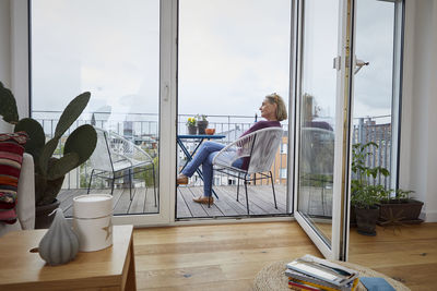 Mature woman at home sitting on balcony