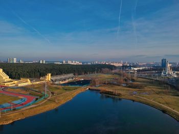 Panoramic view of river by city against blue sky