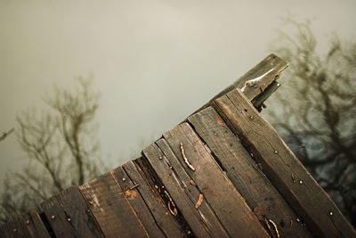 Close-up of wooden fence against sky