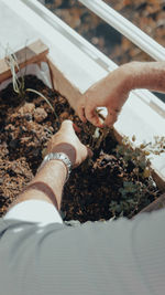 High angle view of man holding cigarette