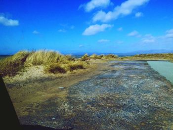 Scenic view of sea against cloudy sky