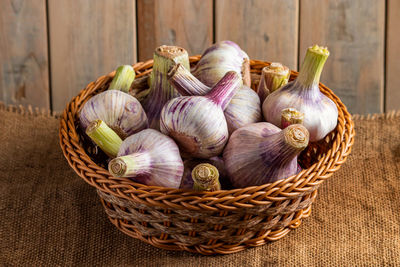 Close-up of garlic in wicker basket on table