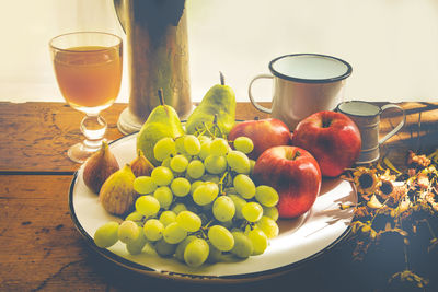 Close-up of fruits and drink on table at home