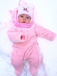 Portrait of cute baby girl sleeping on bed