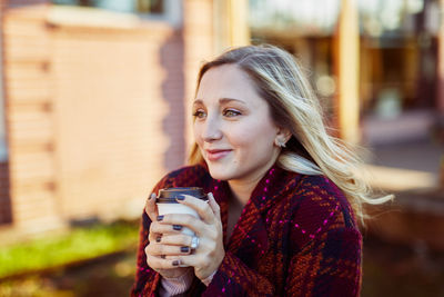 Young woman holding drink