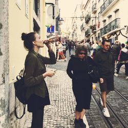 Friends standing on street in city
