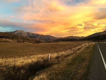 Scenic view of land against sky during sunset