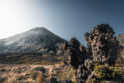 Scenic view of volcanic mountain against clear sky