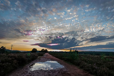 Scenic view of field against sky during sunset