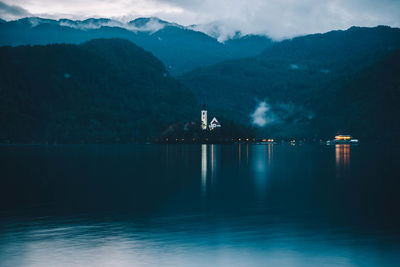 Scenic view of lake and mountains against sky