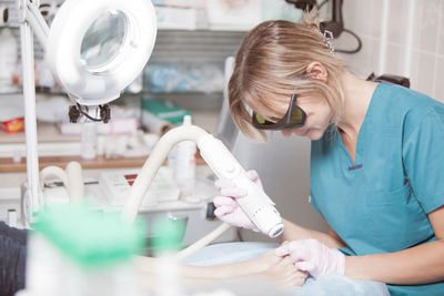 Close-up of woman getting beauty treatment from doctor