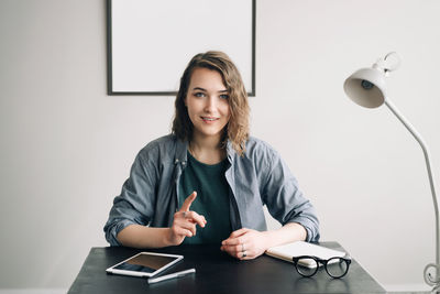 Young businesswoman conducting a video conference from office or home, engaged and confident