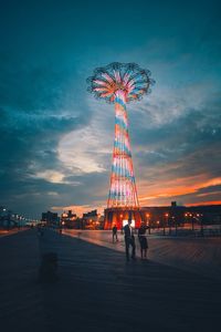 Low angle view of illuminated ferris wheel at night