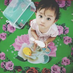 High angle portrait of cute baby girl with toys