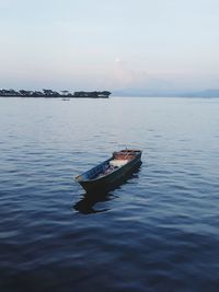 Boat in sea against sky