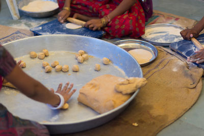 Women rolling dough